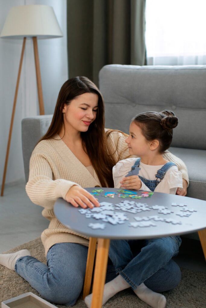 A group of four professionals, two men and two women, are gathered around a conference table reviewing printed charts and documents.