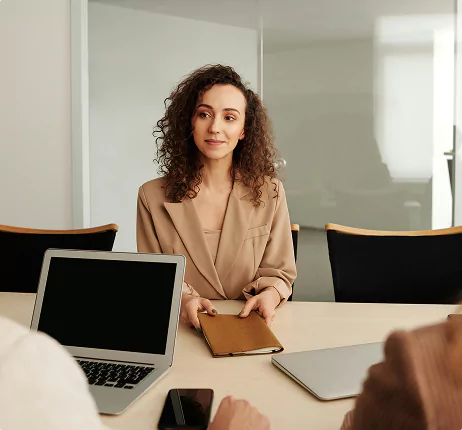 A diverse group of four professionals collaborating at a desk in a modern office.